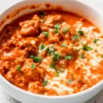 High-protein cottage cheese chicken parm bowl with tomato sauce and melted cheese in a white bowl
