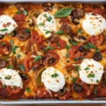 Baked supreme meat lovers pizza casserole topped with sausage, pepperoni, olives, mozzarella, and tomato sauce in a sheet pan